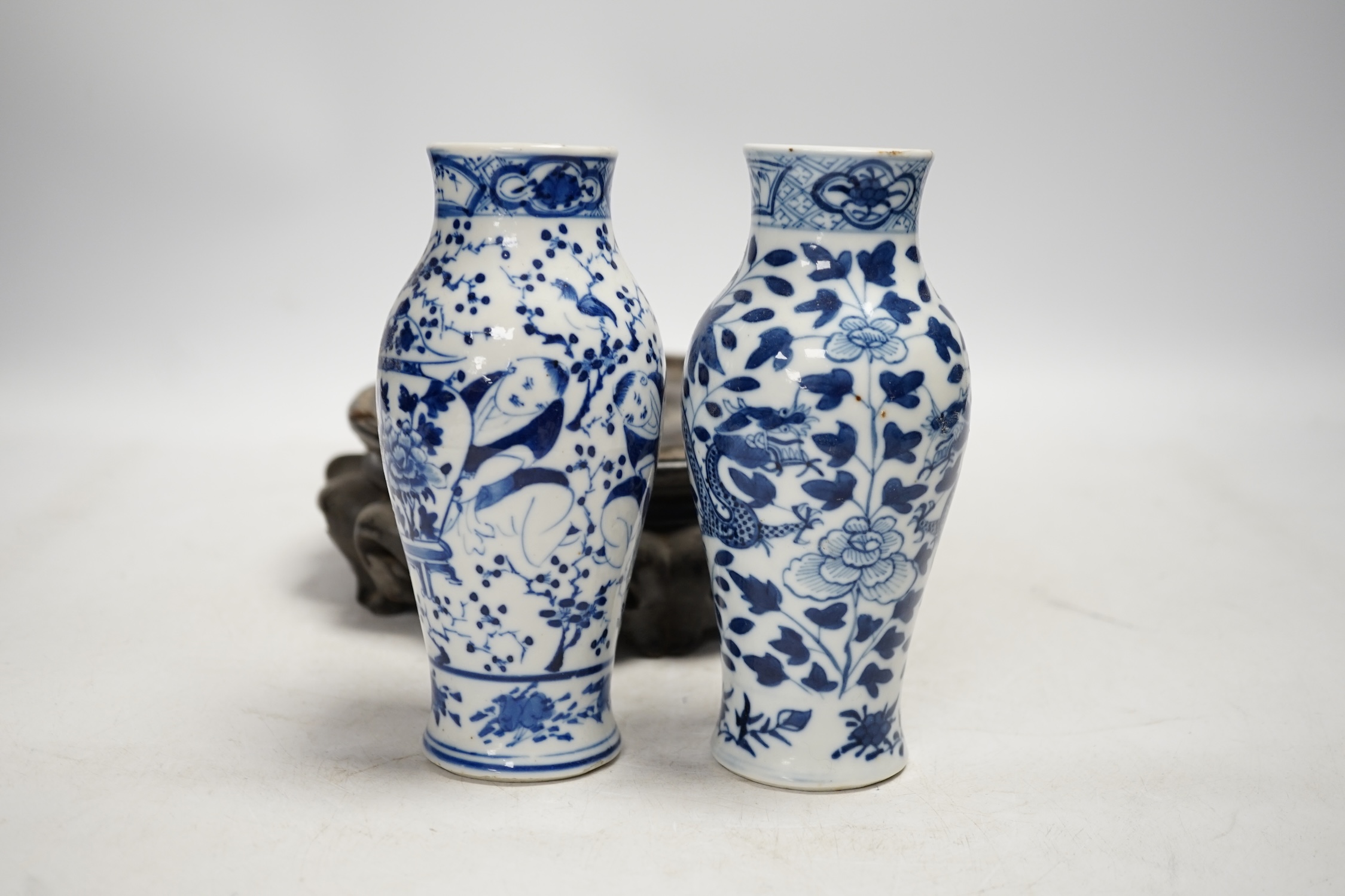 Two Chinese blue and white vases, late 19th century, and a carved hardwood vase stand, vases 15cm high. Condition - one vase good, one with hairline crack, stand poor